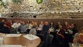 Group of people sitting at a table in a restaurant.